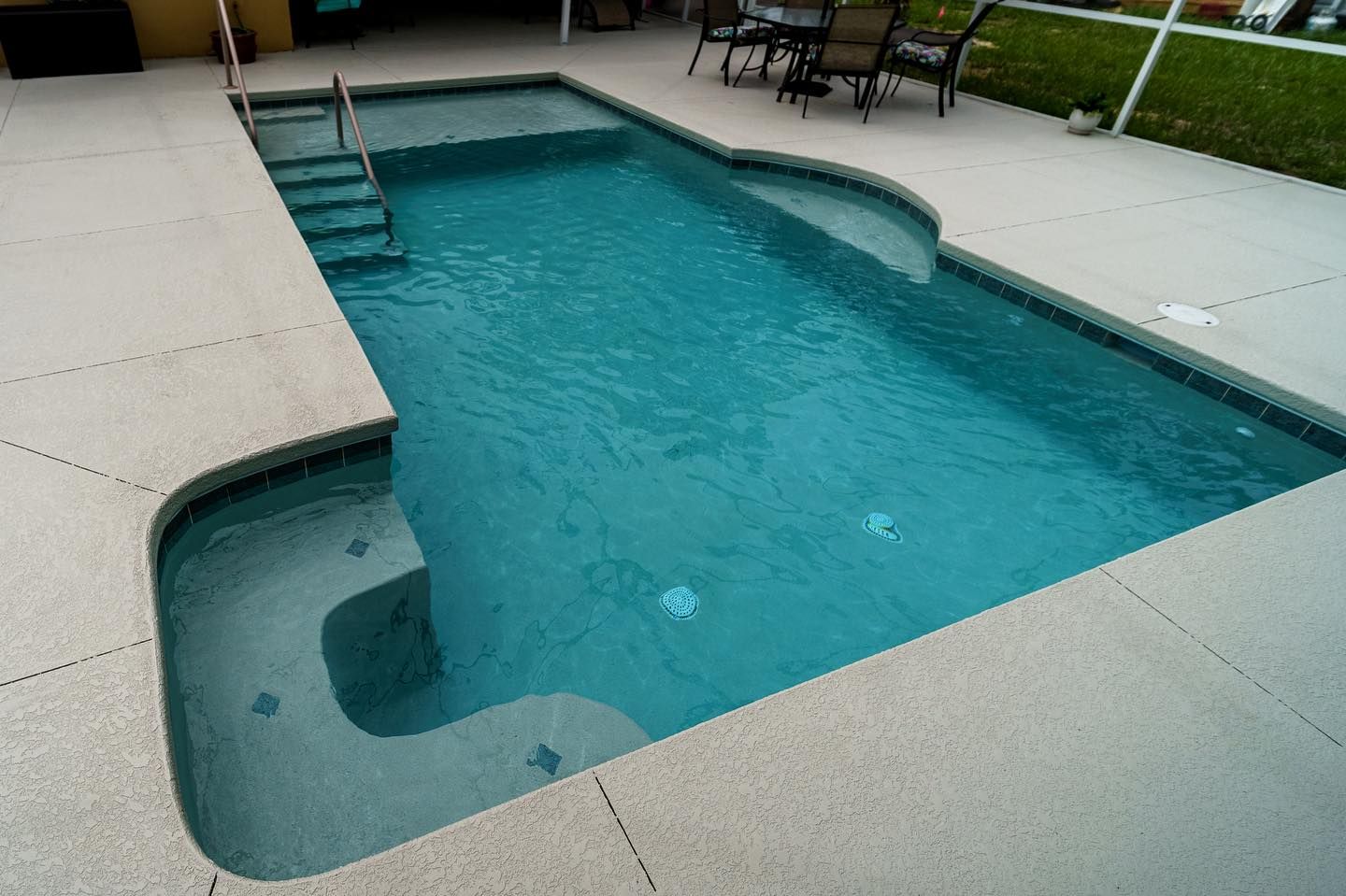 A large swimming pool with stairs leading to it
