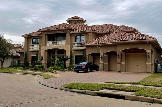 Large house with a car parked in front of it