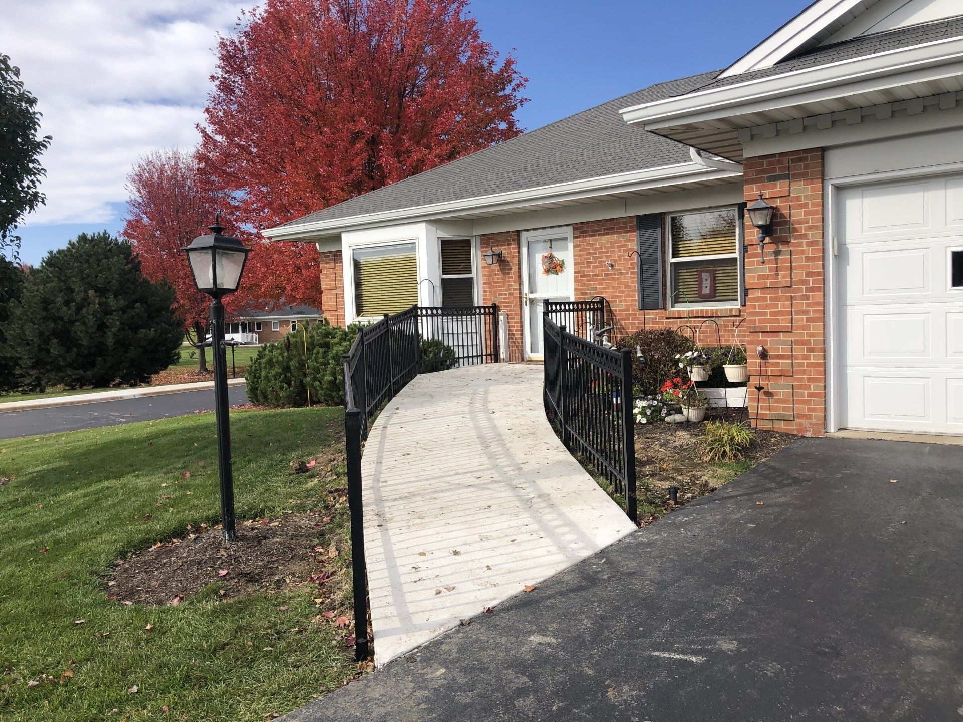 A brick house with a ramp leading to the front door