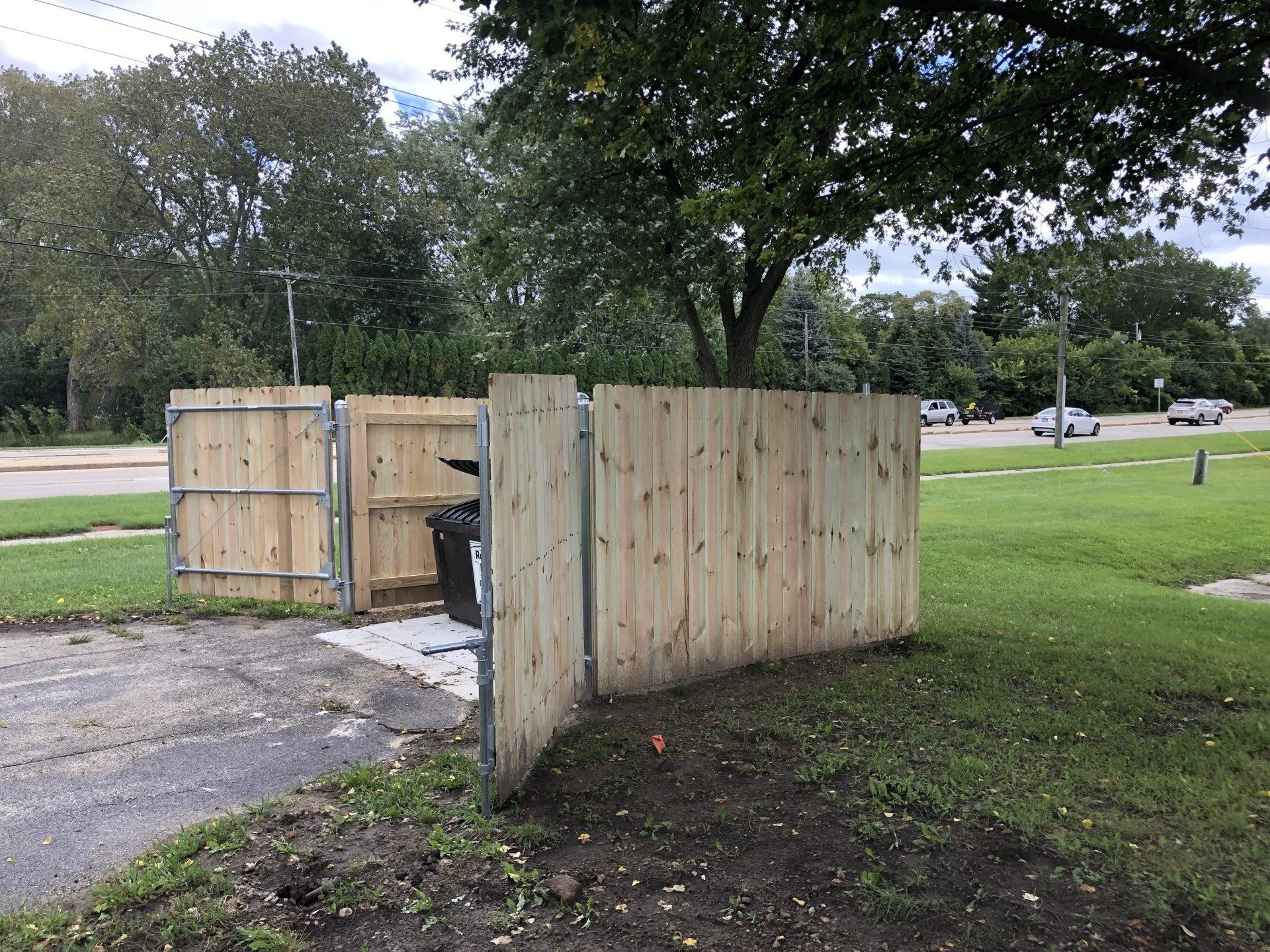 A wooden fence is sitting in the middle of a grassy field.