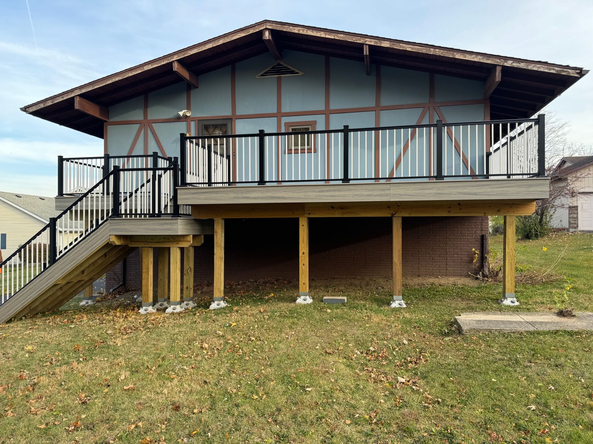 A house with a deck and stairs on the side of it