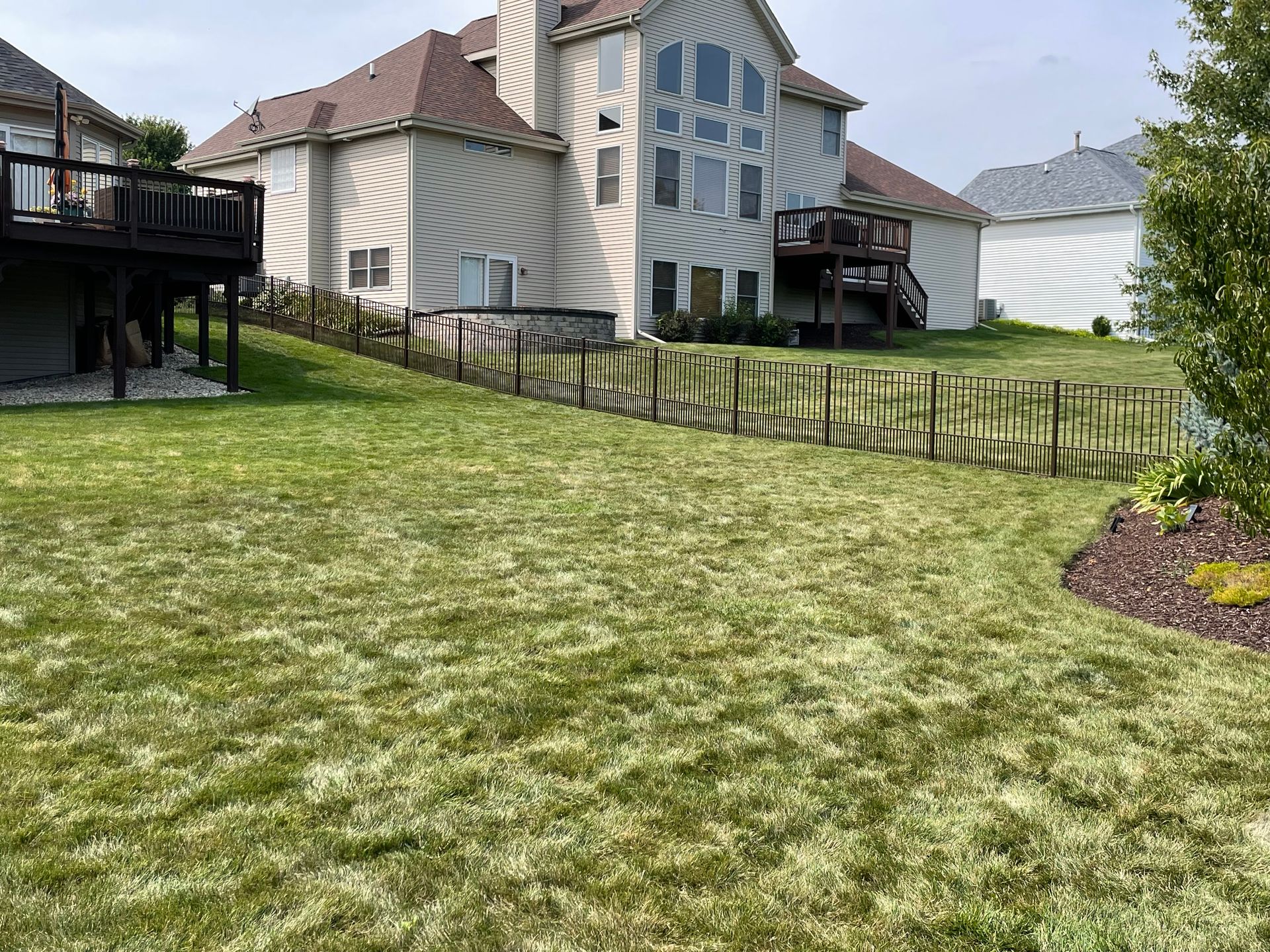 A large house with a large lawn in front of it.