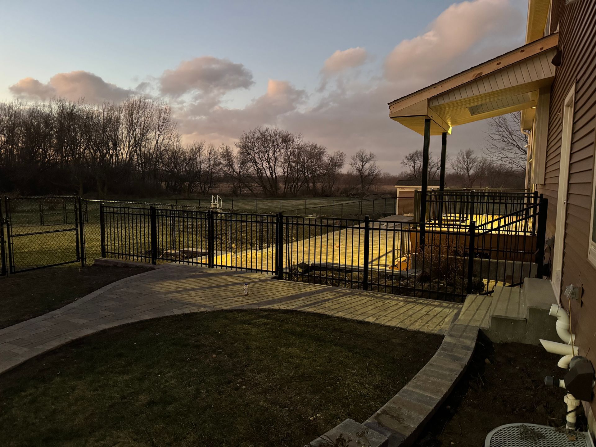 A house with a fence around it and a walkway leading to it.