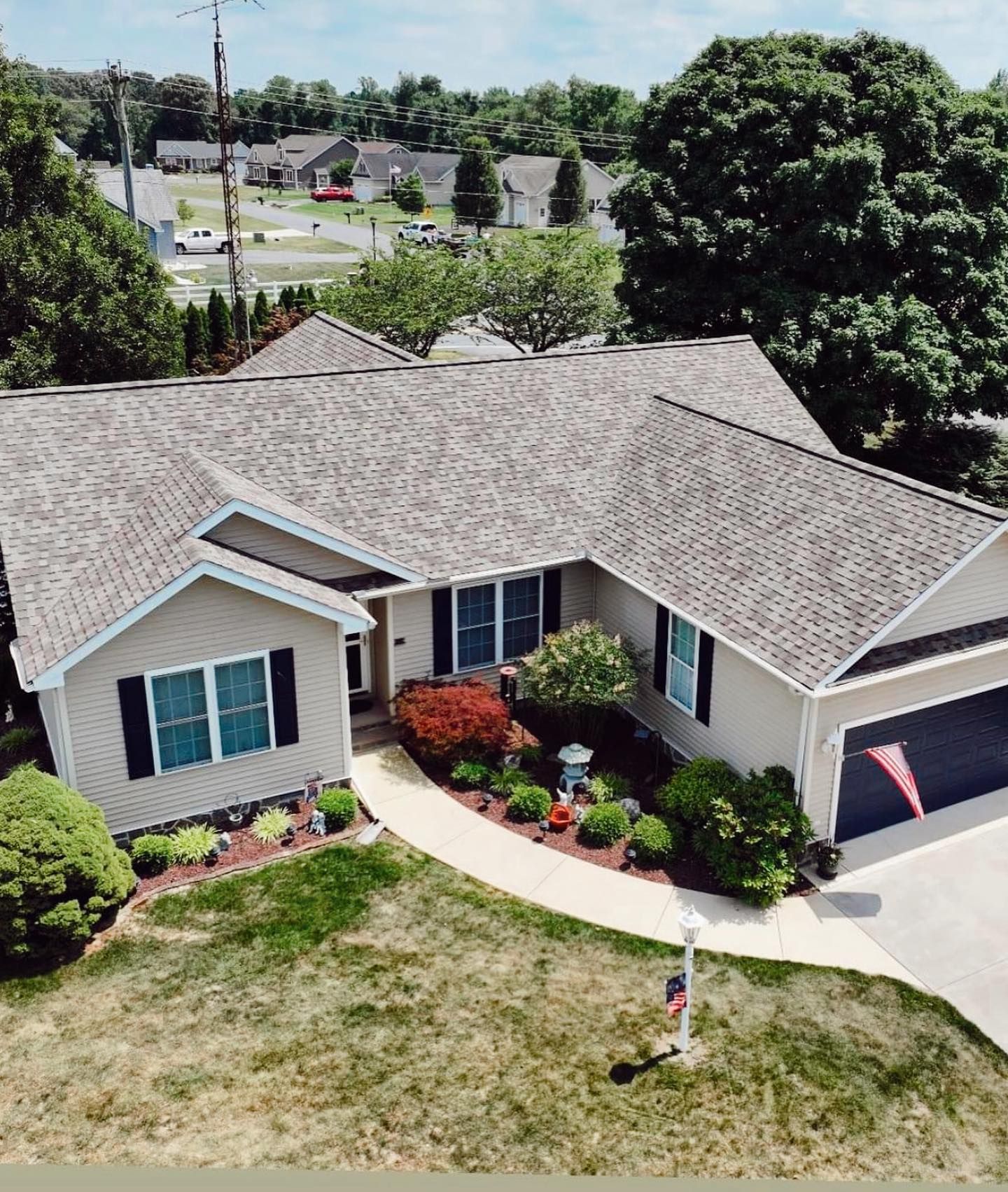 An aerial view of a house with a gray roof