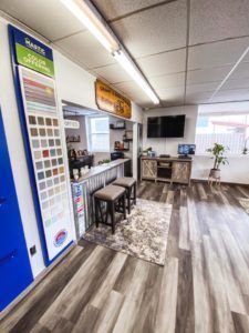 A living room with hardwood floors and a television.