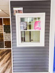 A window is hanging on a wall in a room.