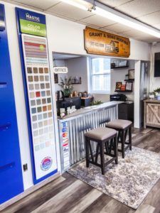 A room with a counter and two stools in it.