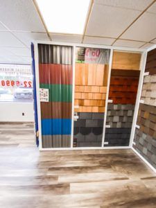 A room with a lot of different types of roofing materials on display.