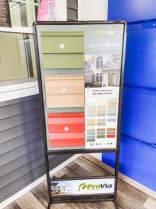 A sign that says ' provia ' on it is on a stand.