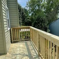 A wooden deck is being built on the side of a house.