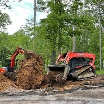 A bulldozer and an excavator are digging a hole in the ground.