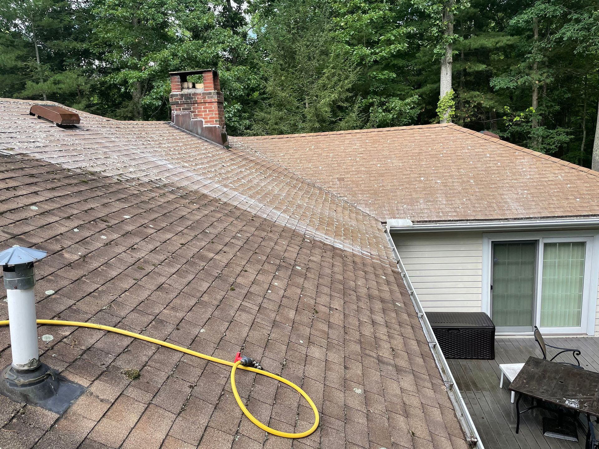A roof appears to be in the process of being cleaned.