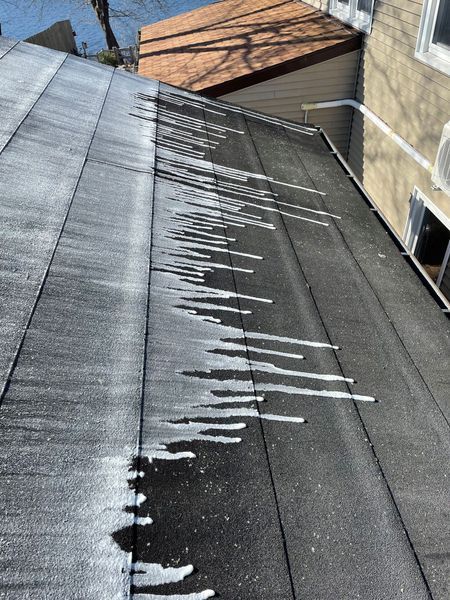 A roof that seems to be undergoing cleaning or treatment.