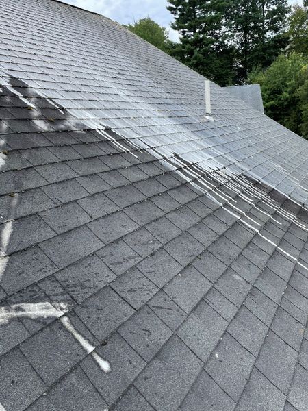 A roof that appears to be undergoing cleaning or treatment.