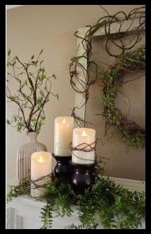 A mantle with candles and a wreath on it