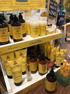 A shelf filled with lots of bottles and tubes of lotion.