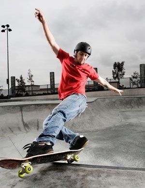 Man skating at a concrete skate park