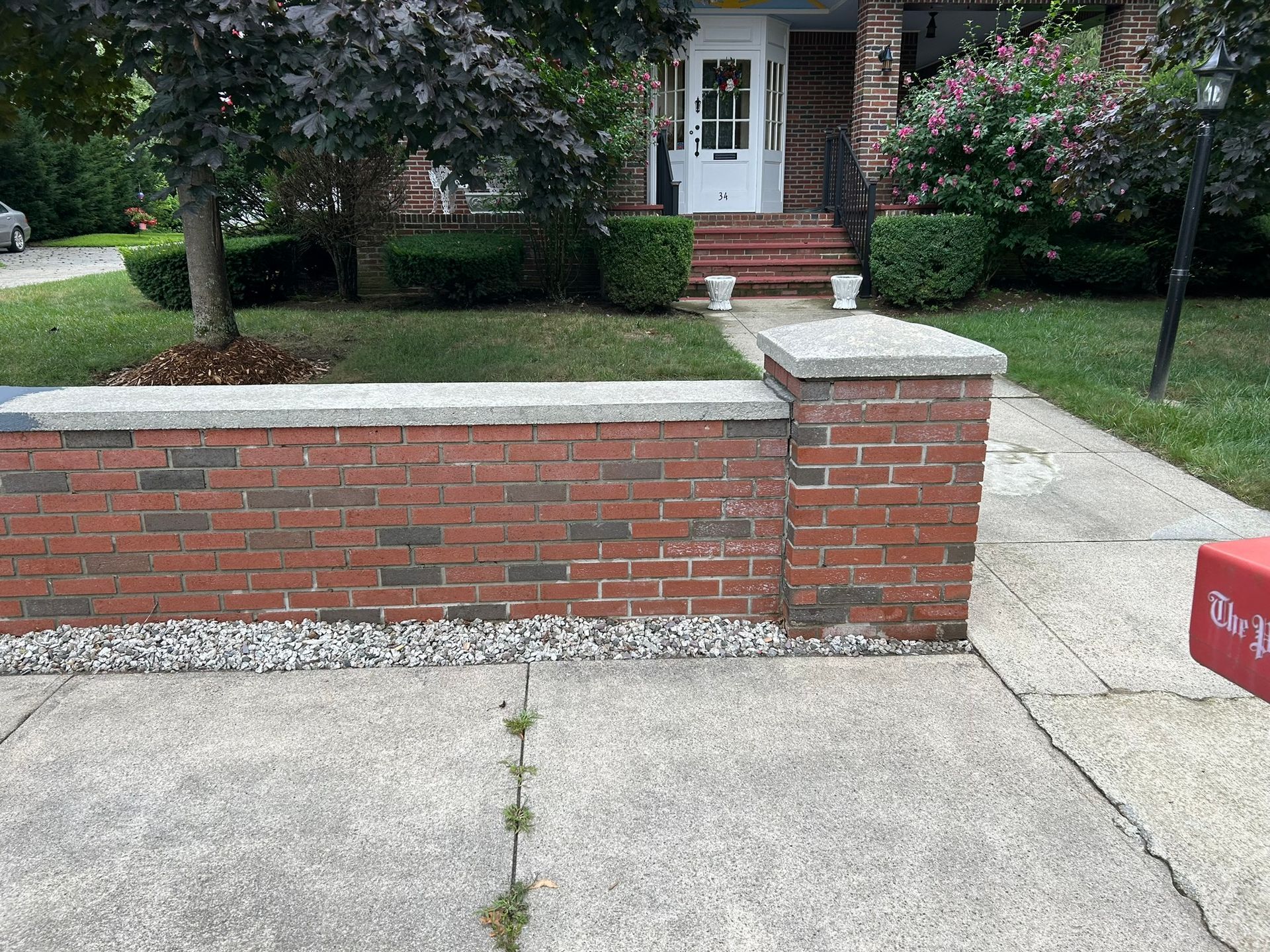 brick wall in front of a house -after