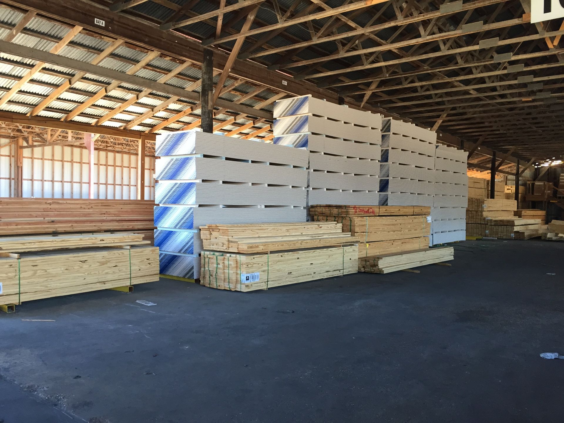 A large warehouse filled with lots of wooden pallets