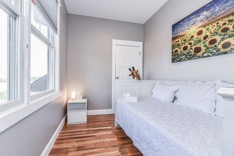 There is a picture of sunflowers on the wall above the bed.