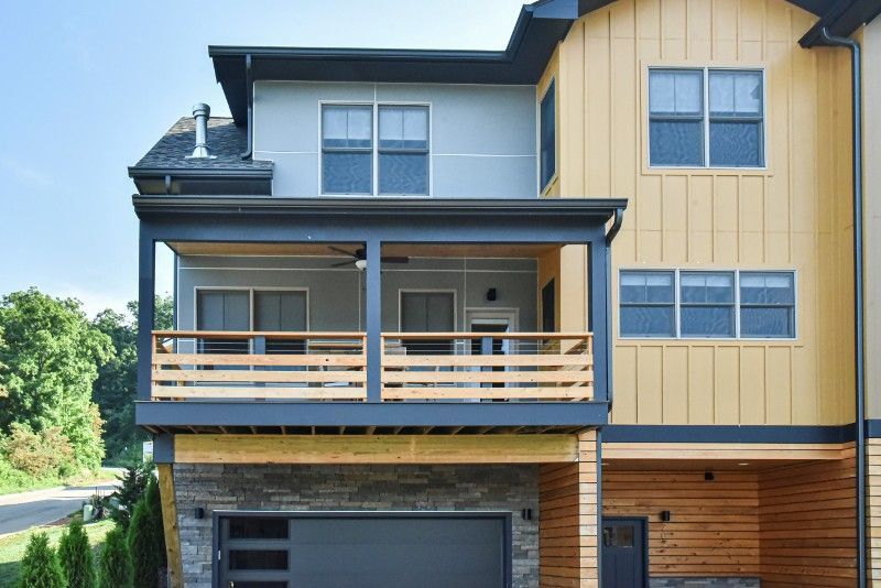 A large house with a large porch and a garage.