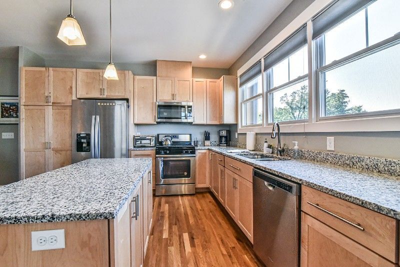 A kitchen with granite counter tops and stainless steel appliances