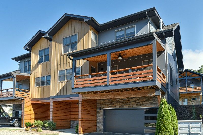 A large house with a car parked in front of it.