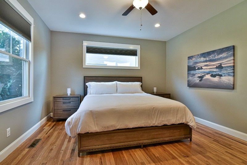 A bedroom with a large bed and a ceiling fan.