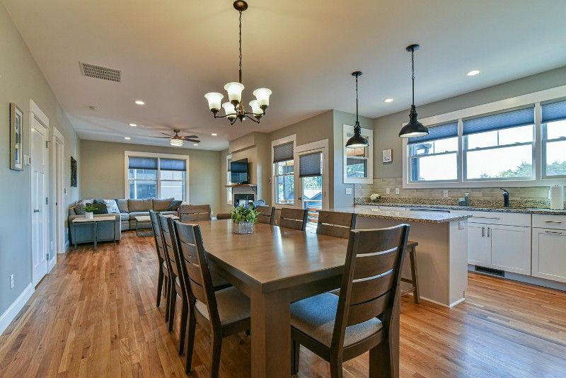 There is a dining table and chairs in the middle of the room.