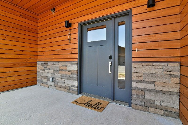 The front door of a house with a welcome mat in front of it.