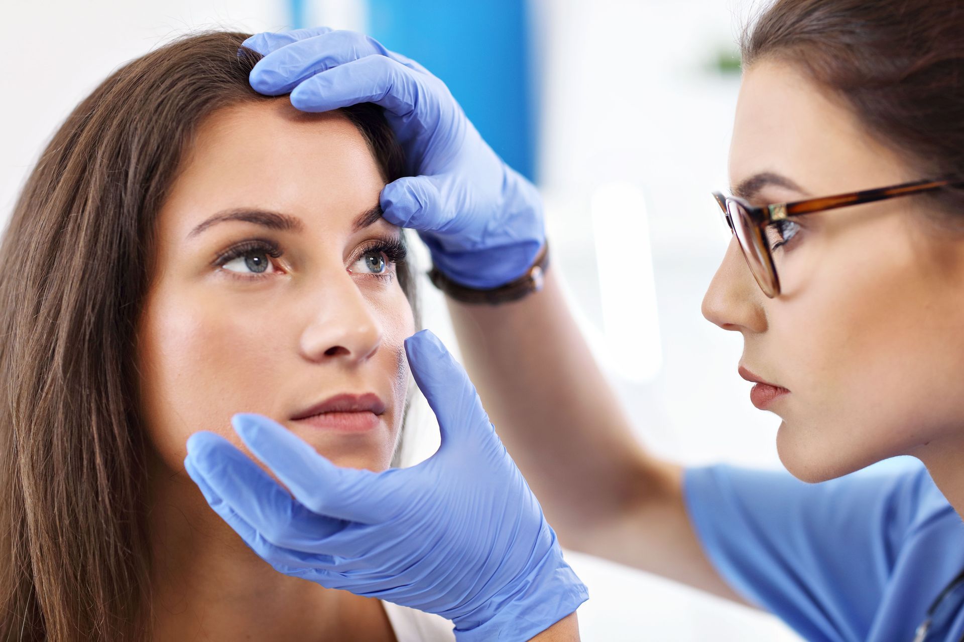 A woman is getting her eyes examined by a doctor.