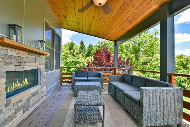 There is a fireplace on the porch of a house.