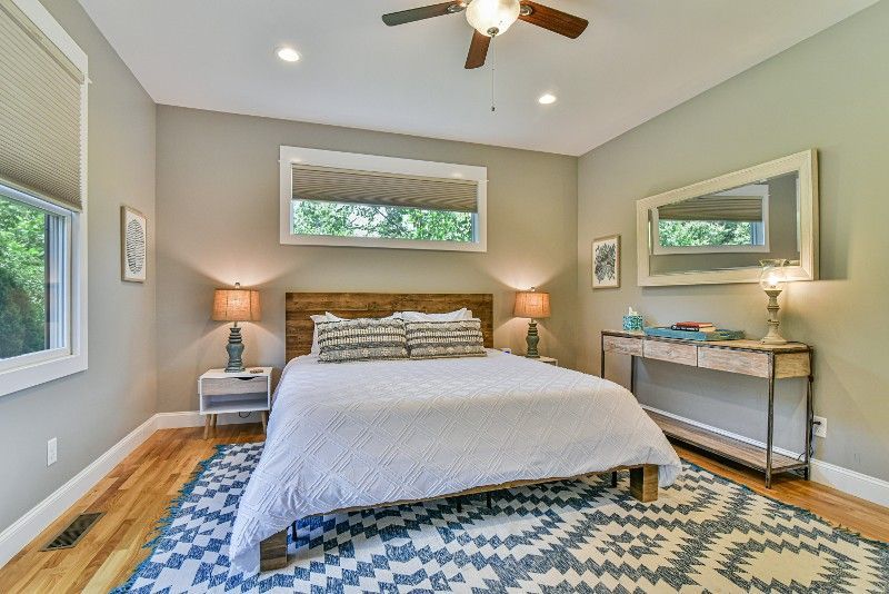 A bedroom with a king-size bed and a ceiling fan.