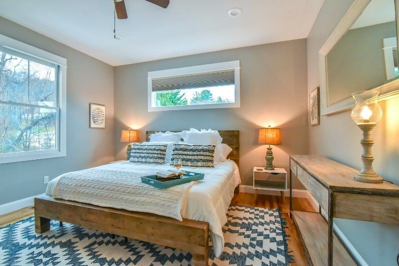 A bedroom with a king size bed and a rug