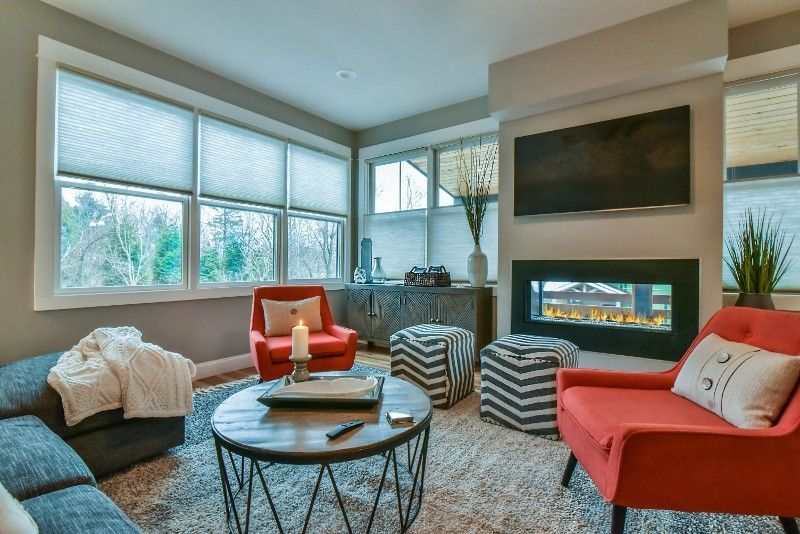 A living room with a fireplace and a flatscreen TV.