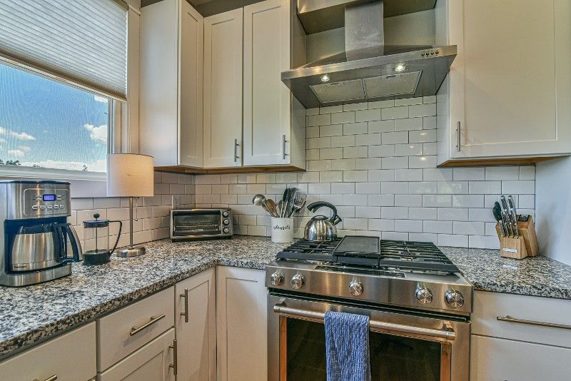 A kitchen with stainless steel appliances and granite counter tops.