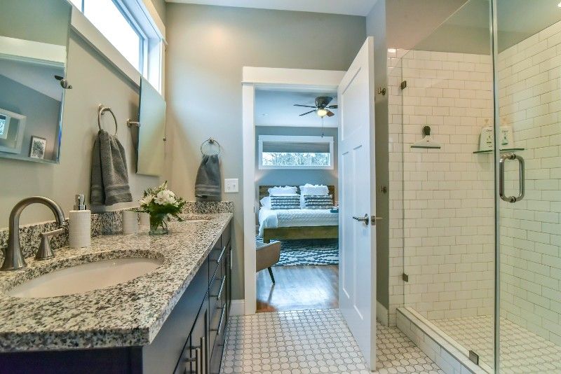 A bathroom with two sinks and a walk-in shower.