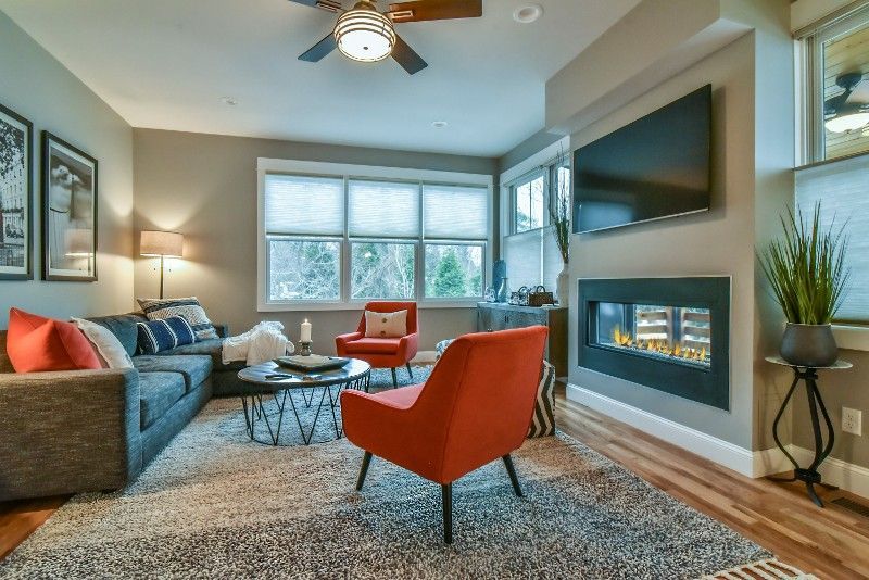 A living room with a fireplace and a flatscreen tv.