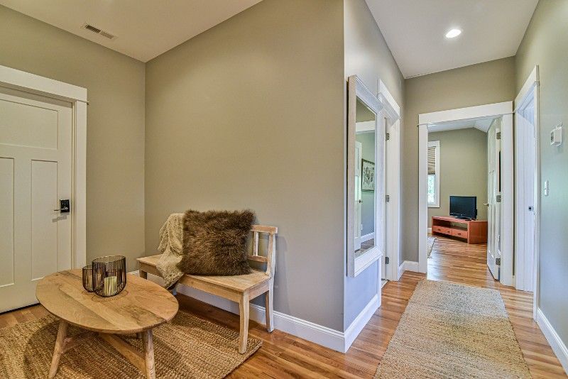 A hallway with a bench and a table in a house.