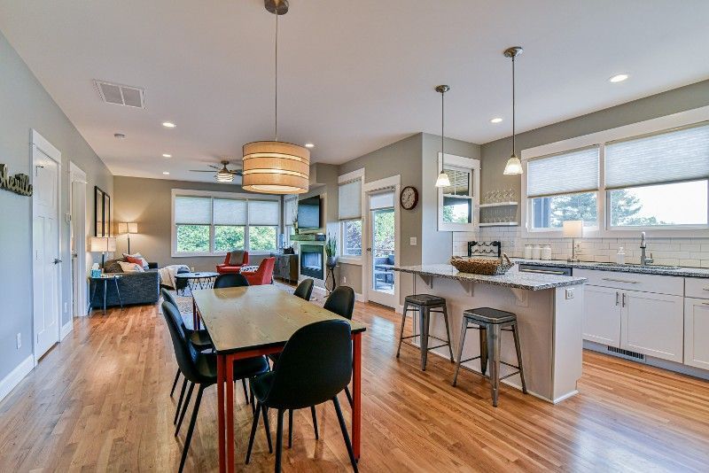 There is a dining table and chairs in the middle of the room.