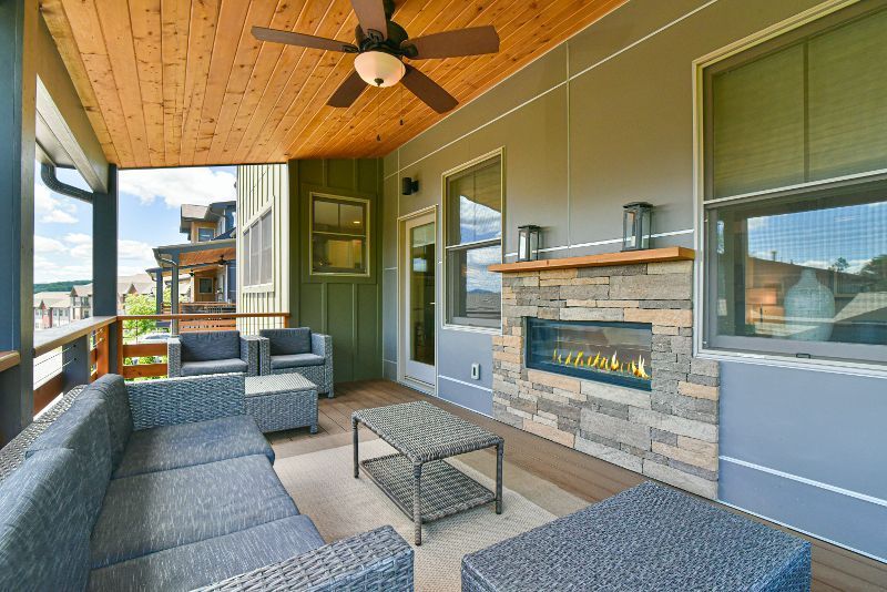 There is a fireplace on the porch of a house.