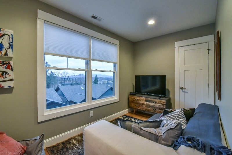 A living room with a couch and a flat screen tv.