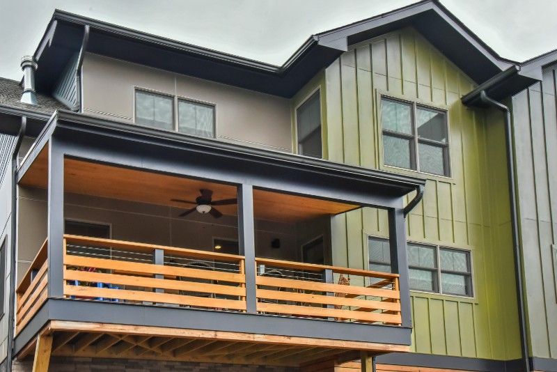 A large house with a balcony and a ceiling fan