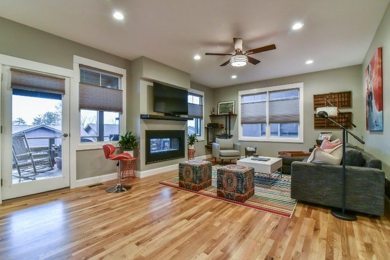 A living room with hardwood floors and a fireplace.