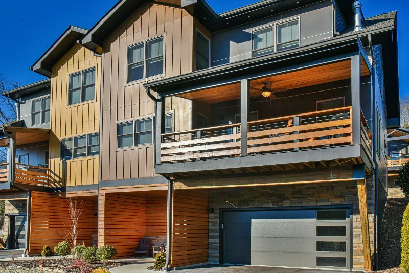 A large house with a lot of windows and a garage.