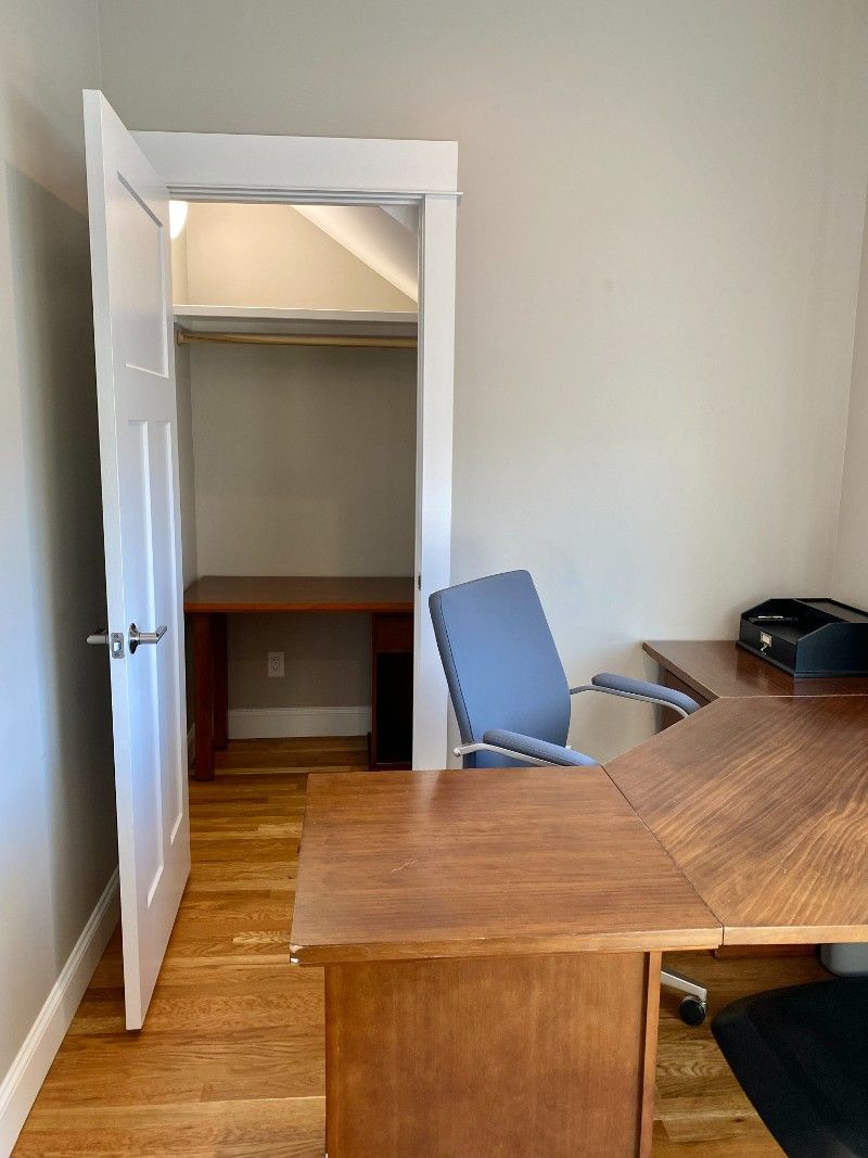 A room with a desk and a chair in it