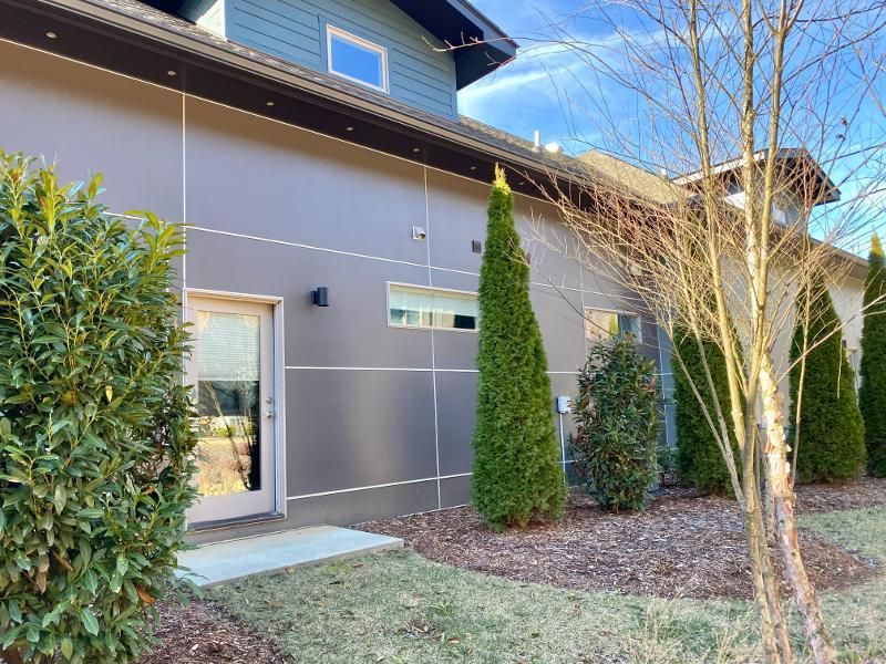 A large house with a lot of trees in front of it
