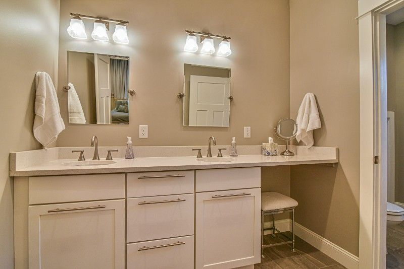 A bathroom with two sinks and two mirrors.