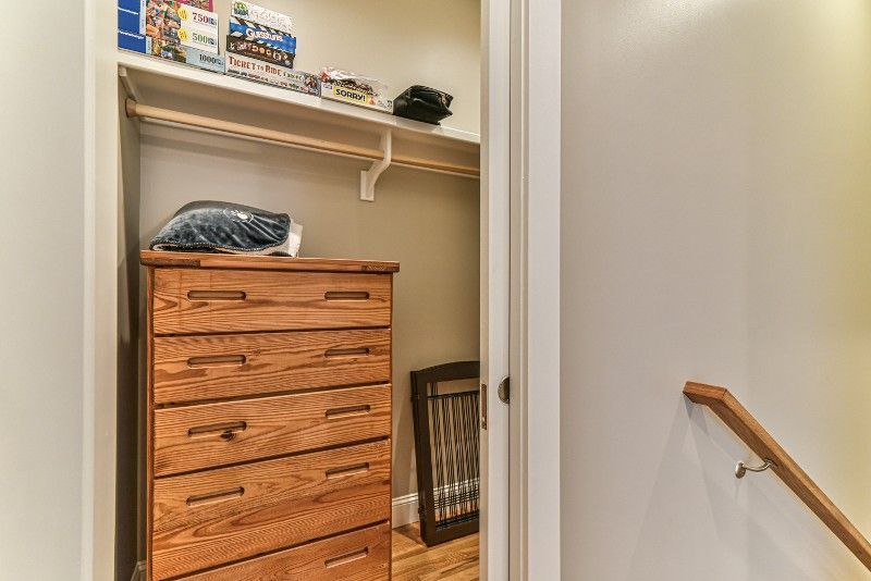 There is a dresser in the closet next to the stairs.