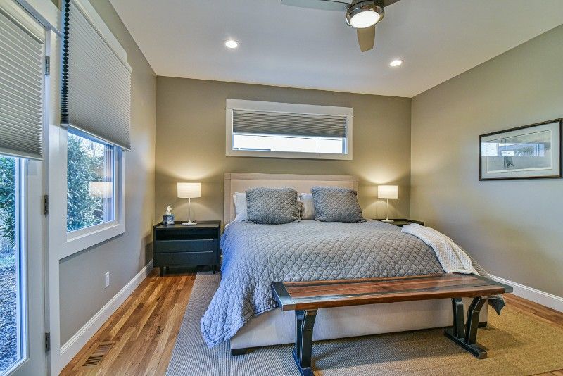 A bedroom with a king size bed and a bench.